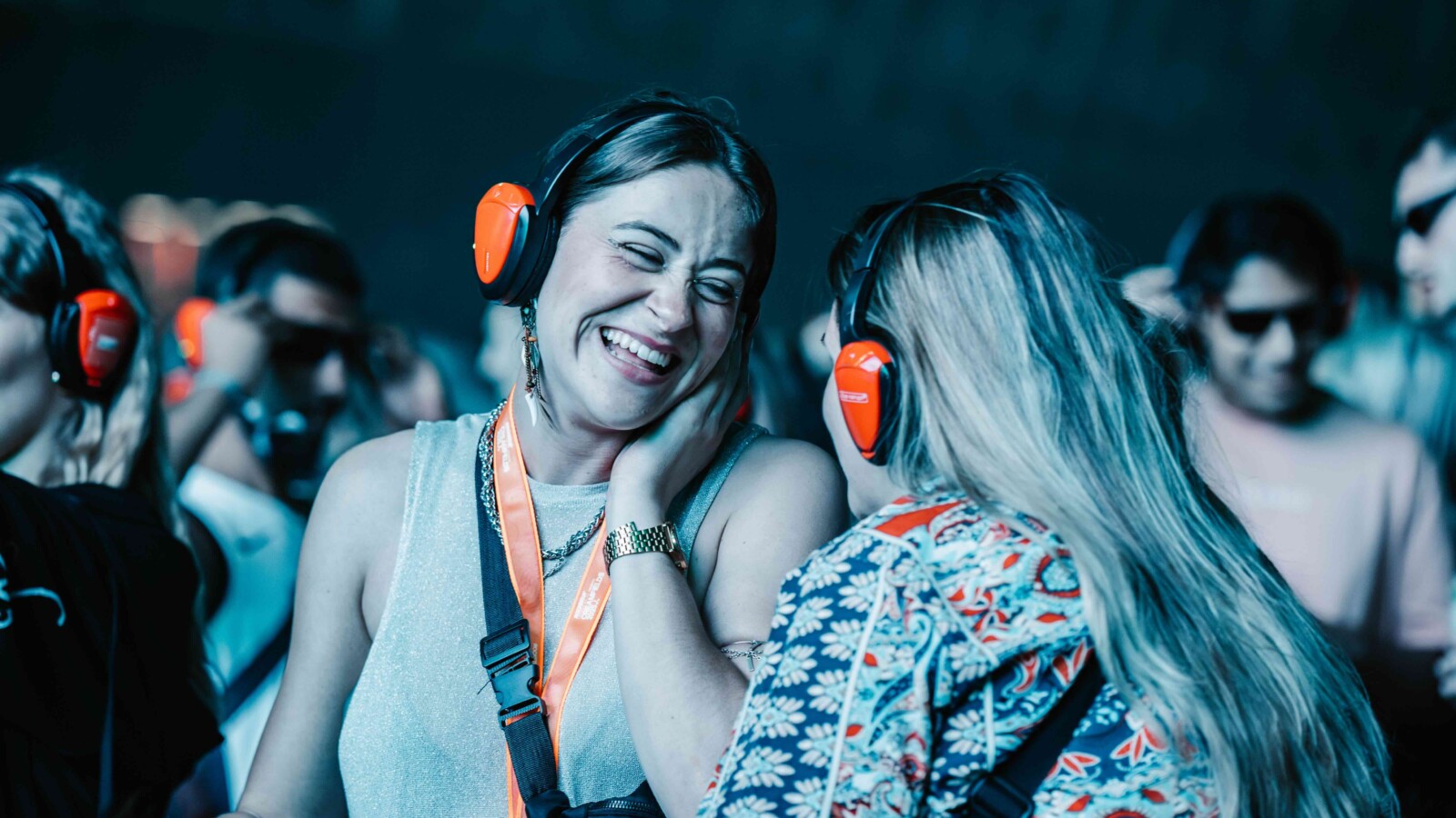 Rockstar Energy presents Creamfields 2025 - two friends with headphones on laughing and enjoying the music.